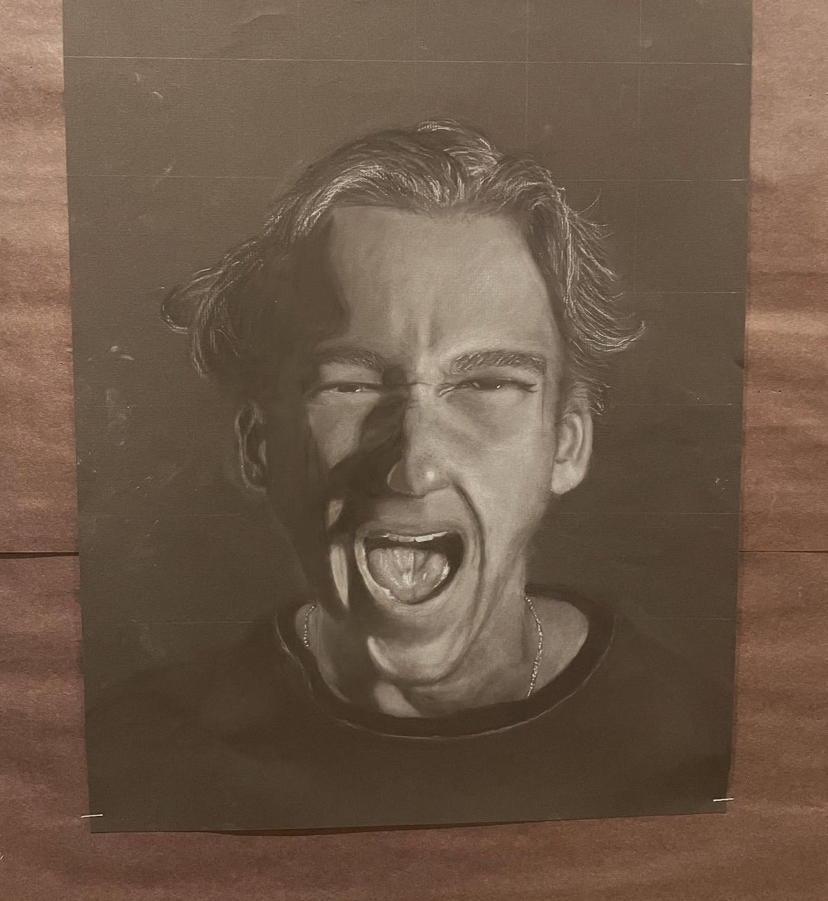 Nakobe, self-portrait in white charcoal on black paper
